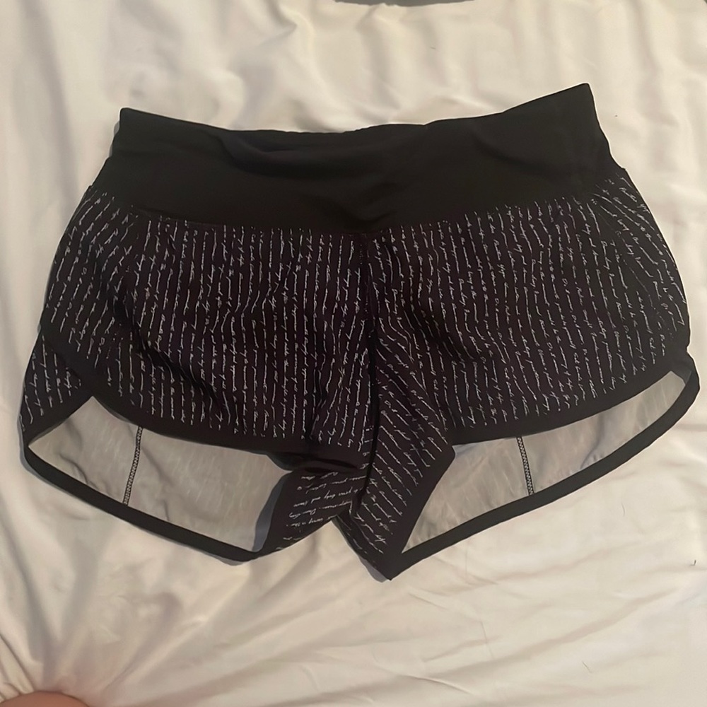 Lululemon speed-ups, size 2 in black with writing.